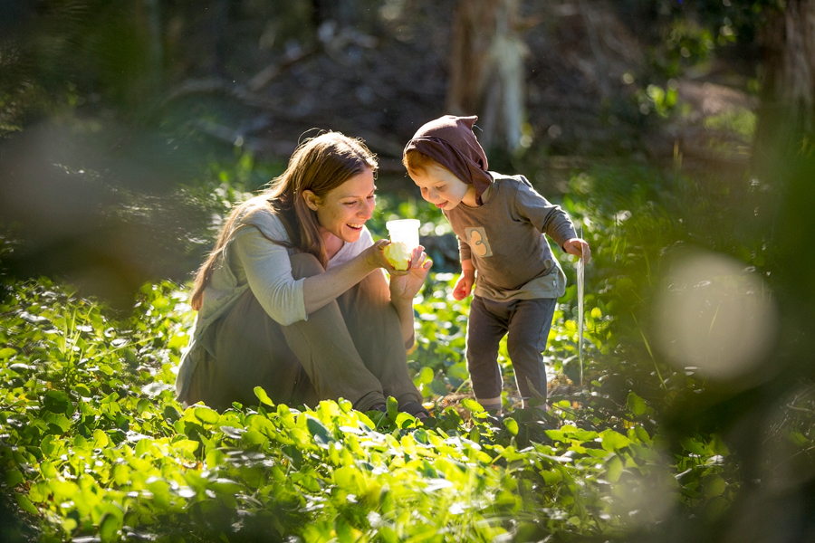 A mother and child marvelling at something in the bush